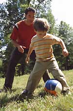 Vater und Sohn beim Ballspielen.